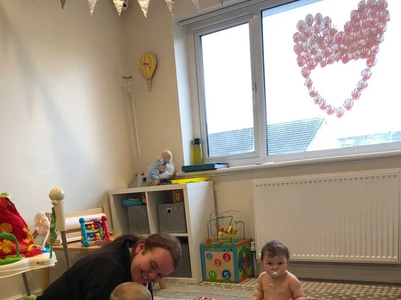Nursery practitioner playing with a baby on the floor mat at Ready Steady Go Childcare Worle