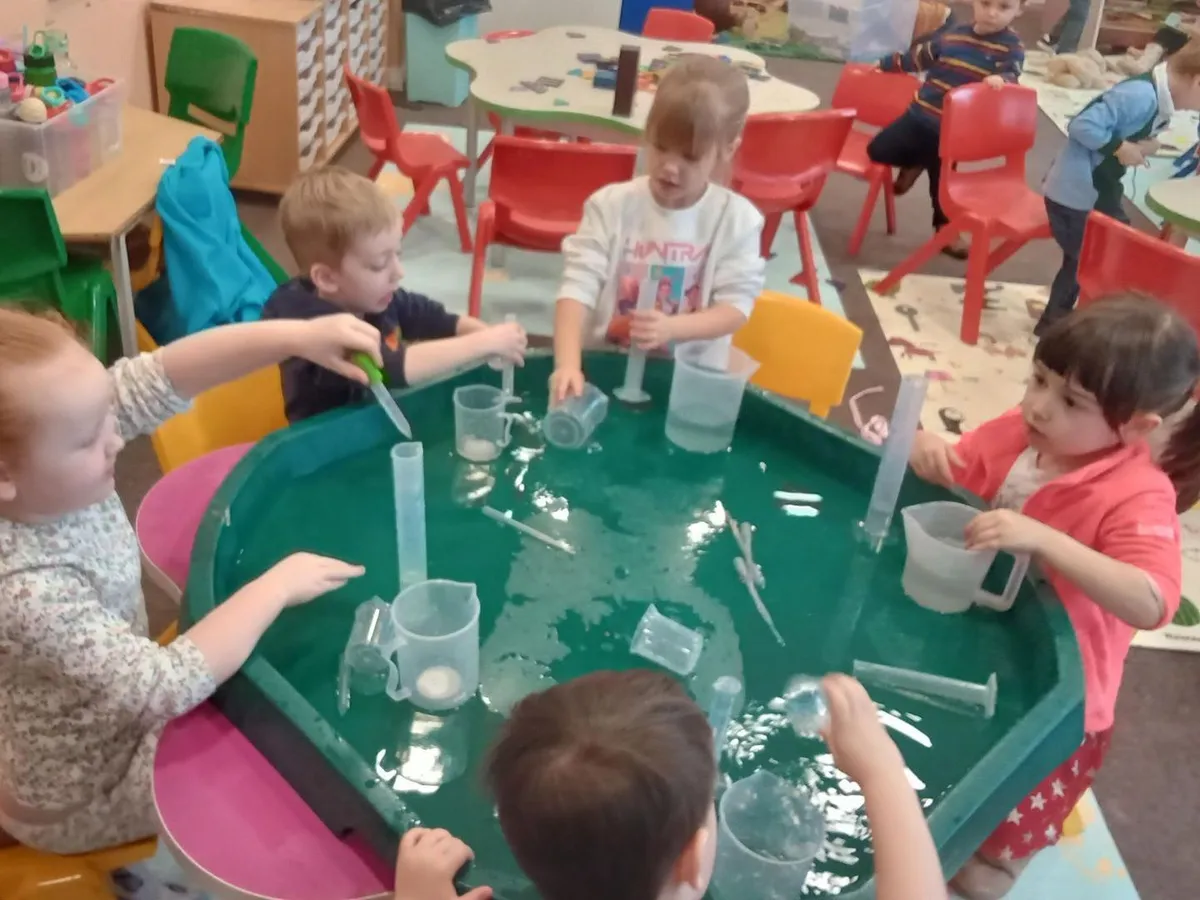 Preschool children investigating a water tray together at Ready Steady Go Childcare Milton